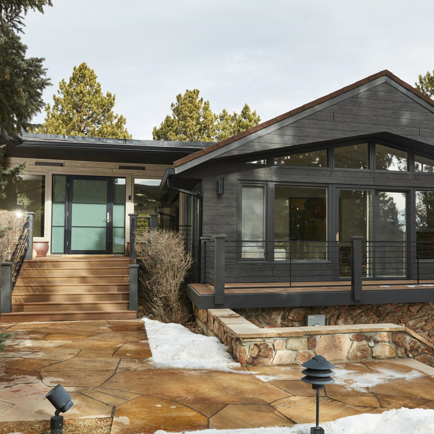 a cottage home with wooden facade panels